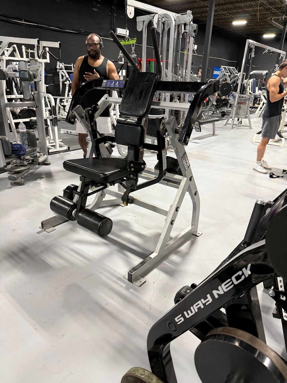 5-way neck machine and gym floor at Full Tilt Barbell Club