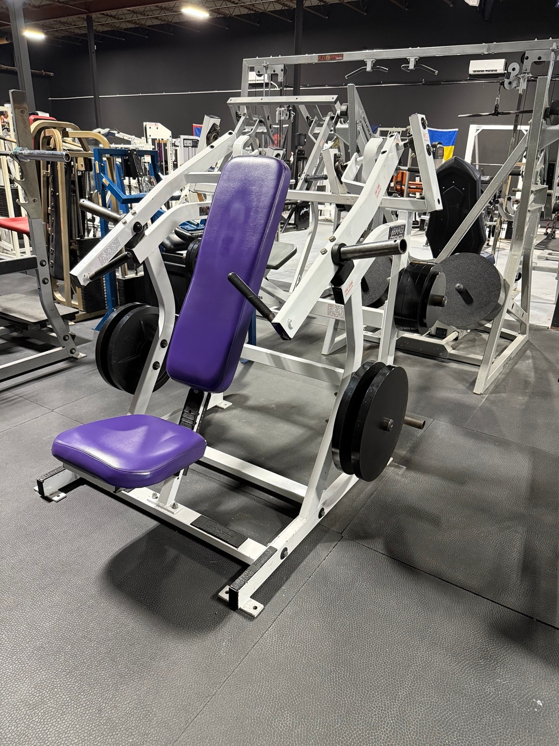 Purple plate-loaded press machine at Full Tilt Barbell Club