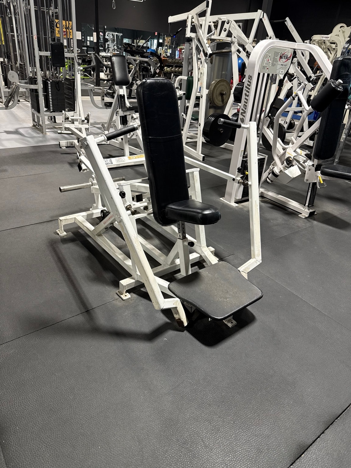 Plate-loaded chest press machine at Full Tilt Barbell Club