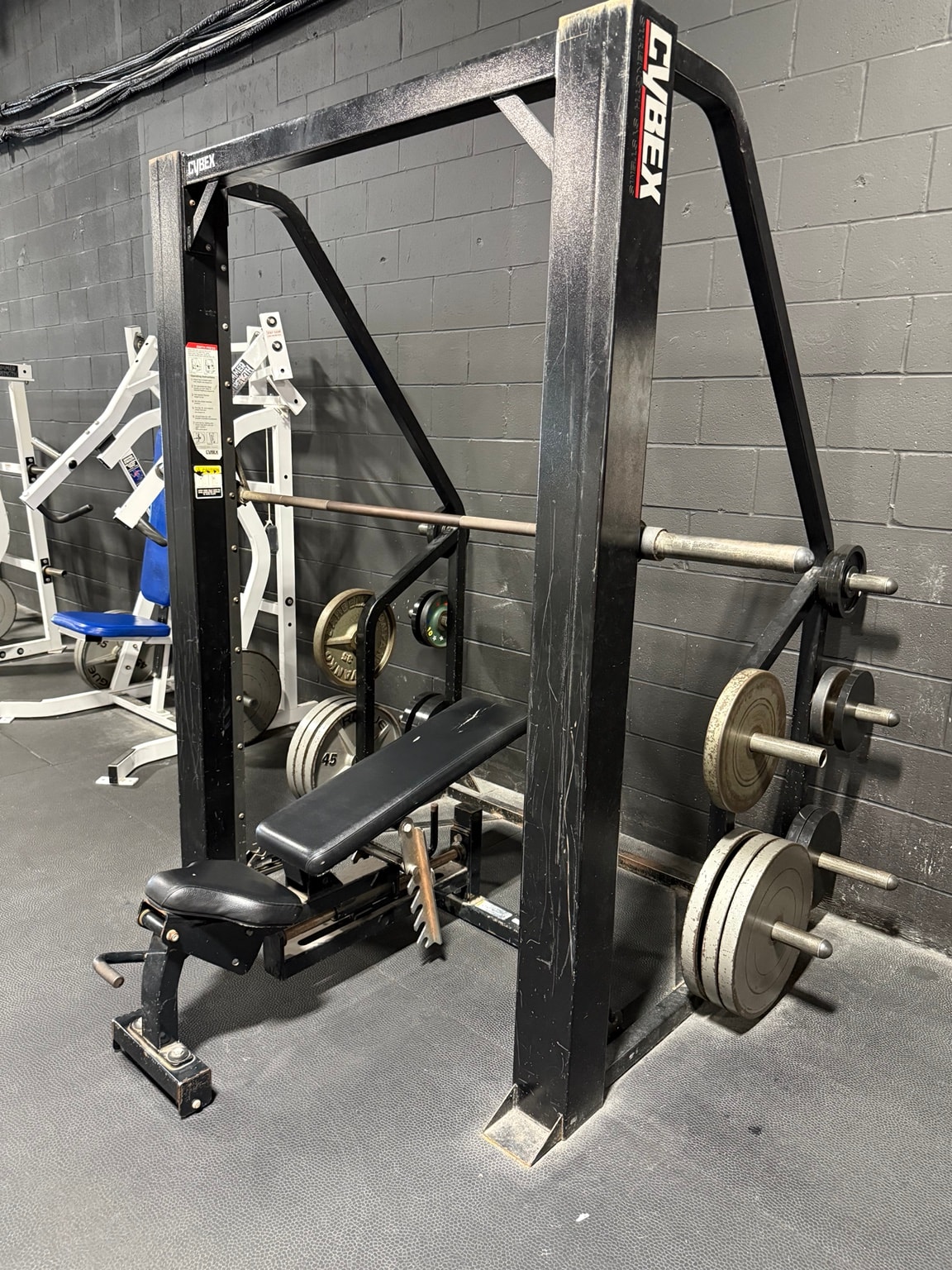 Cybex Smith machine with weight plates at Full Tilt Barbell Club